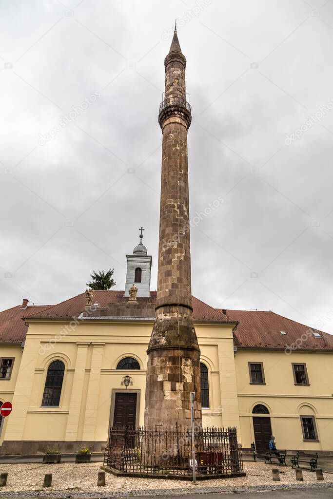 Eger, Hungary-Eger Minaret in cloudy and foggy weather against a background of gray clouds. The minaret was built shortly after the Turkish victory in 1596.