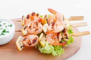 Classic shrimp skewers with garlic dip clipart