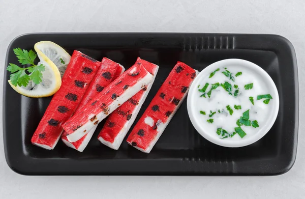 Grilled surimi sticks a form of kamaboko, a processed seafood made of white fish flesh with garlic dip — Stock Photo, Image