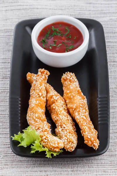 Fried fish fingers with sauce and sesame — Stock Photo, Image