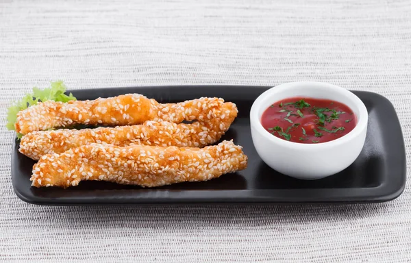Fried fish fingers with sauce and sesame — Stock Photo, Image