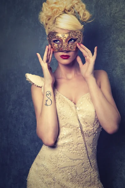 Woman in golden mask — Stock Photo, Image