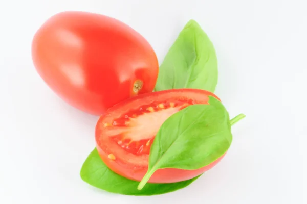 Tomatoes (roma - solanum lycopersicum) with green leaves - on white background — Stock Photo, Image