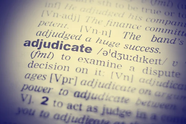 Wörterbuch-Definition von Adjudikat. Nahaufnahme mit Papierstrukturen — Stockfoto