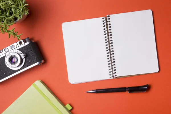 Tourism, travel concept. Office desk table with notepad, camera and supplies. Top view. Copy space for text.