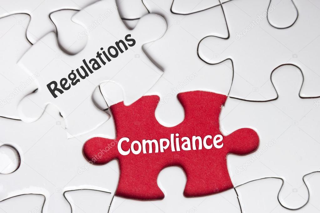 Compliance and Regulation words written on white puzzle piece,business