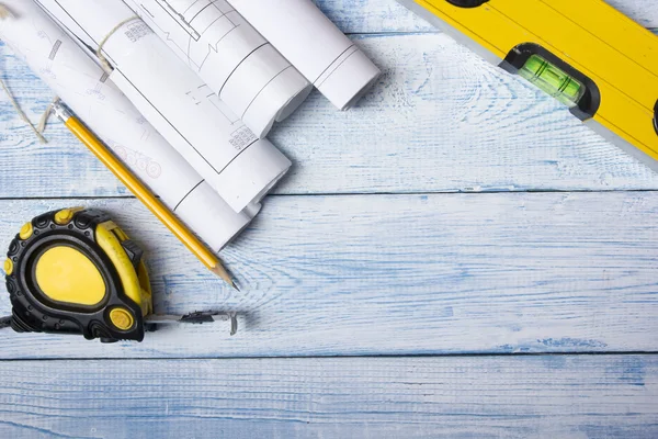 Architect worplace top view. Architectural project, blueprints, blueprint rolls on wooden desk table. Construction background. Engineering tools. Copy space. — Stock Photo, Image