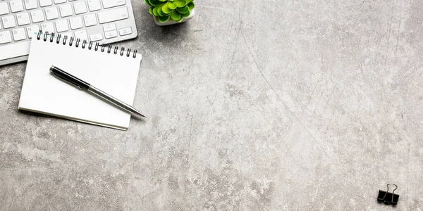 White desk office with laptop, smartphone and other work supplies with cup of coffee. Top view with copy space for input the text. Designer workspace on desk table essential elements on flat lay