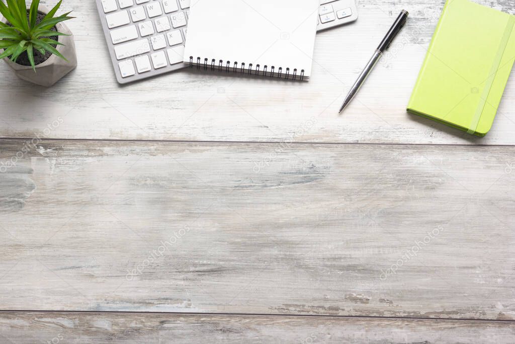 White desk office with laptop, smartphone and other work supplies with cup of coffee. Top view with copy space for input the text. Designer workspace on desk table essential elements on flat lay