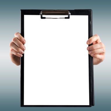 Female hands holding medical clipboard with blank sheet of paper on blurred background. Copy space.