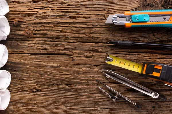 Architectural project, blueprints, blueprint rolls and divider compass, calipers on vintage wooden background. Construction concept. Engineering tools. Copy space — Stock Photo, Image