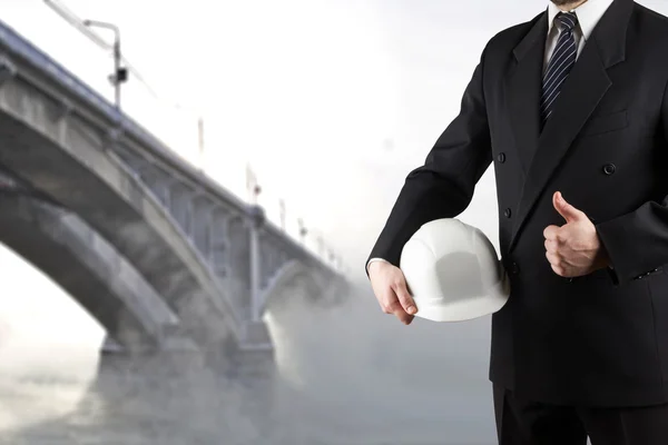 Close up of engineer hand holding white safety helmet for worker — Stock Photo, Image