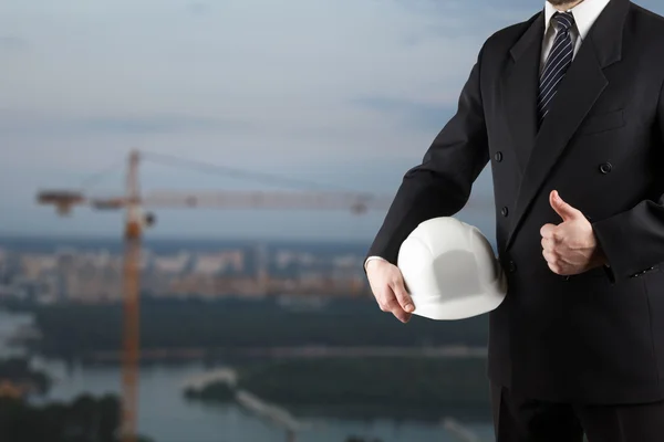 Close up of engineer hand holding white safety helmet for worker — Stock Photo, Image