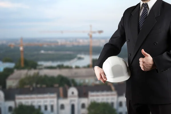 Close up of engineer hand holding white safety helmet for worker — Stock Photo, Image