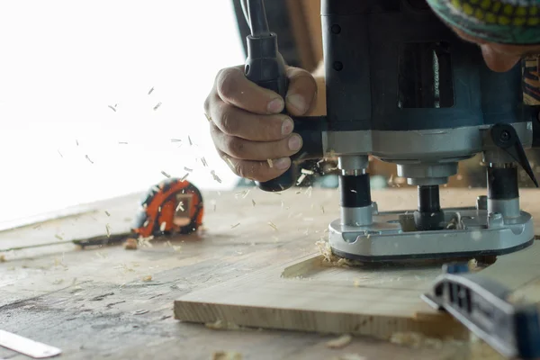 Close-up of carpenter cutting a wooden plank. Selective focus. Copy space — Stock Photo, Image