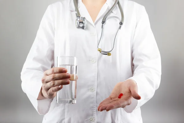 Doctor with medical stethoscope and green apple analyzing cardiogram results — Stock Photo, Image