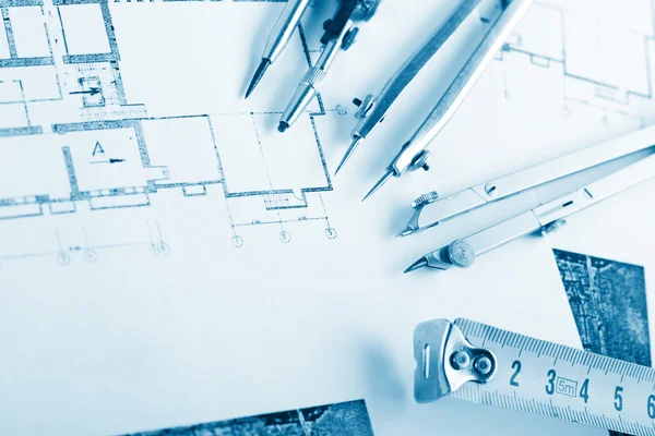 Architectural project, blueprints, blueprint rolls on plans. Engineering tools view from the top. Copy space. Construction background. Blue toned — Stock Photo, Image