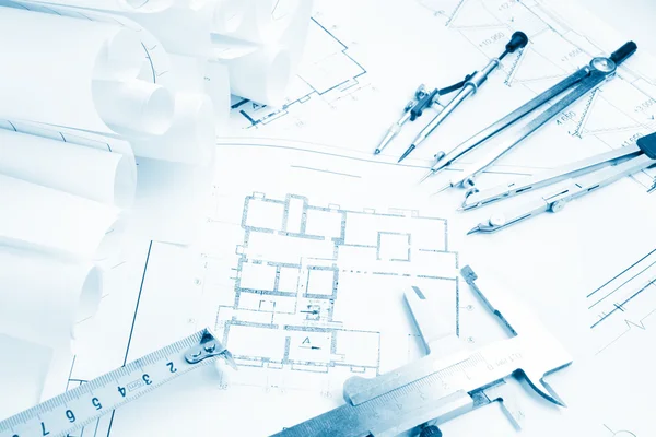 Architectural project, blueprints, blueprint rolls and divider compass, calipers, folding ruler on plans Engineering tools view from the top. Copy space. Construction background. Blue toned — Zdjęcie stockowe