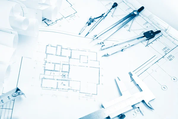 Architectural project, blueprints, blueprint rolls and divider compass, calipers, folding ruler on plans Engineering tools view from the top. Copy space. Construction background. Blue toned — Stock Photo, Image