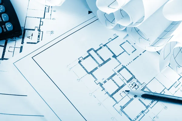 Architectural project, blueprints, blueprint rolls and divider compass, calipers, folding ruler on plans Engineering tools view from the top. Copy space. Construction background. Blue toned — Φωτογραφία Αρχείου