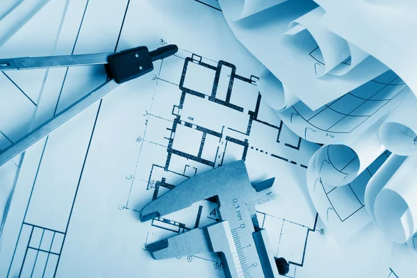 Architectural project, blueprints, blueprint rolls and divider compass, calipers, folding ruler on plans Engineering tools view from the top. Copy space. Construction background. Blue toned — 스톡 사진