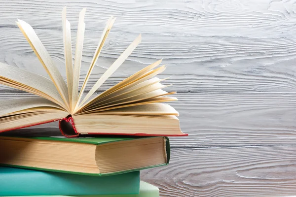 Pila di libri colorati su tavolo di legno. Torniamo a scuola. Copia spazio — Foto Stock