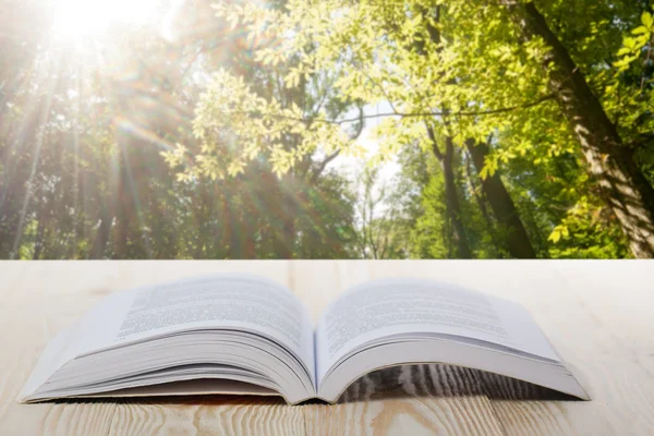 Open book on wooden table on natural blurred background. Back to school. Copy Space — Stock Photo, Image