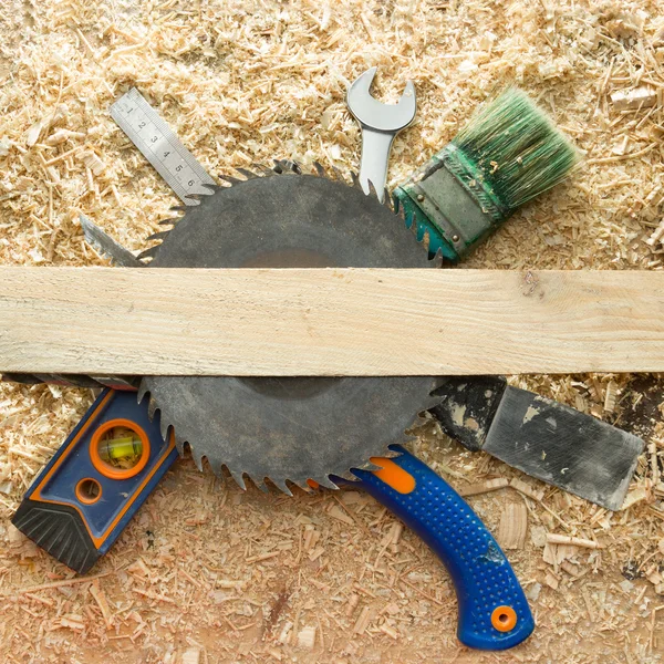 Carpenter tools on wooden table with sawdust. — Stock Photo, Image