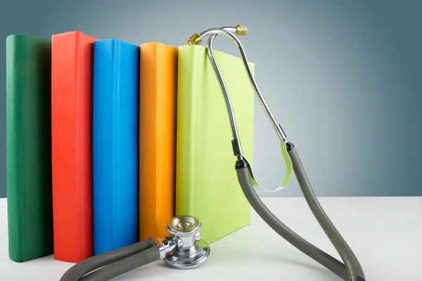 Hardback books on the table, medical  stethoscope. Medical professional education and information concept. Back to school, copy space. — Stock Photo, Image