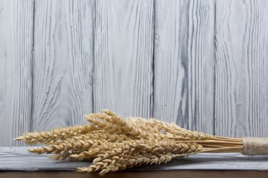 Sheaf of Wheat over Wood Background. Harvest concept.