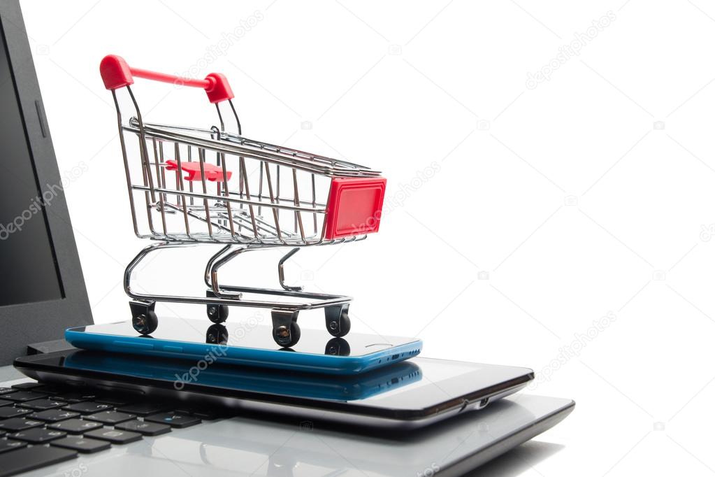 Online shopping concept - Empty Shopping Cart, laptop and tablet pc, smartphone isolated on white background. Copy space for text.