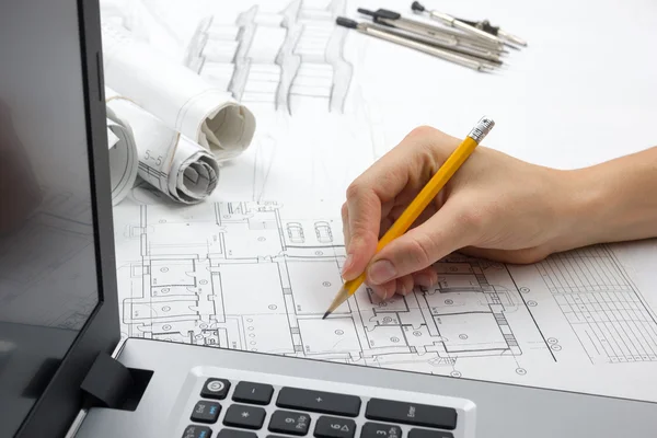 Architect working on blueprint. Architects workplace - architectural project, blueprints, ruler, calculator, laptop and divider compass. Construction concept. Engineering tools Stock Image