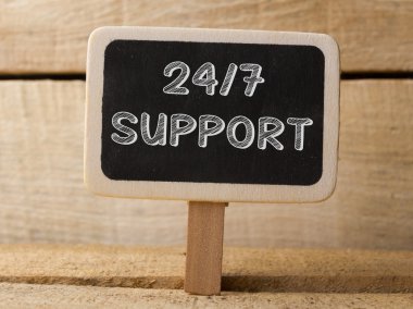 Support 247  text write on Chalkboard at wooden background