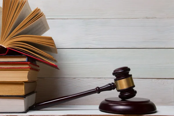 Law book with wooden judges gavel on table in a courtroom or law enforcement office. — Stock Photo, Image