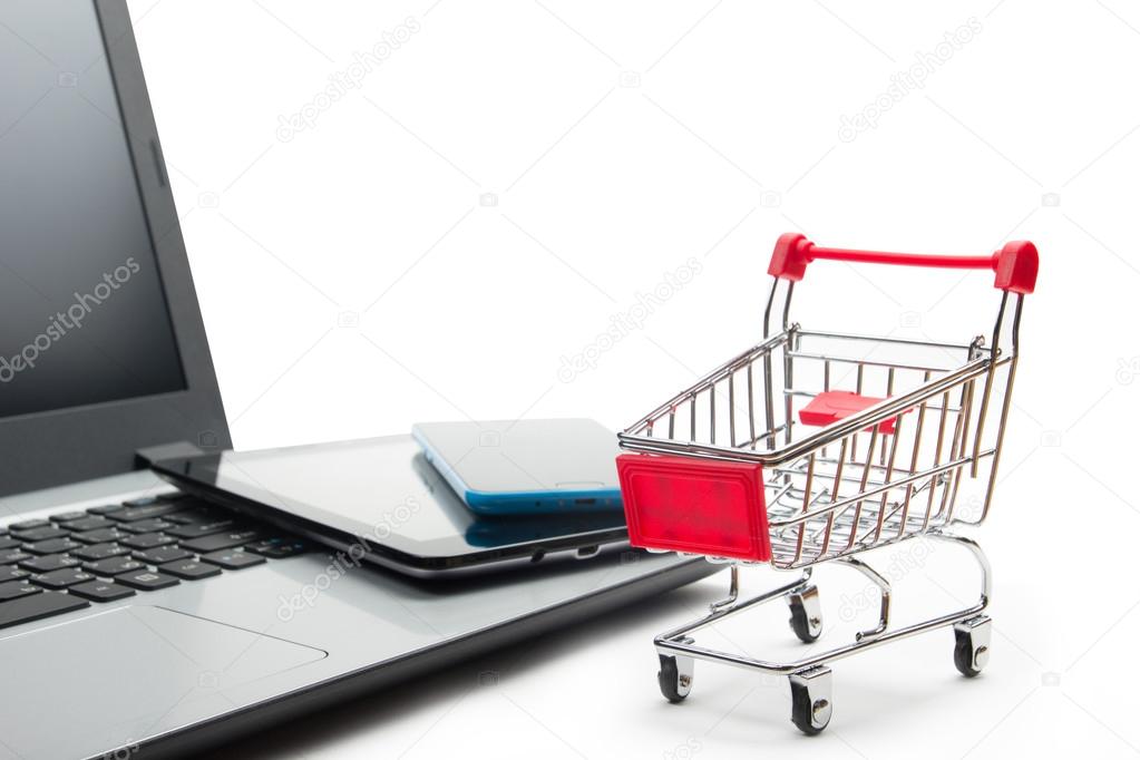 Online shopping concept - Empty Shopping Cart, laptop and tablet pc, smartphone isolated on white background. Copy space for text.