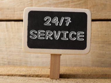 Service 247  text write on Chalkboard at wooden background