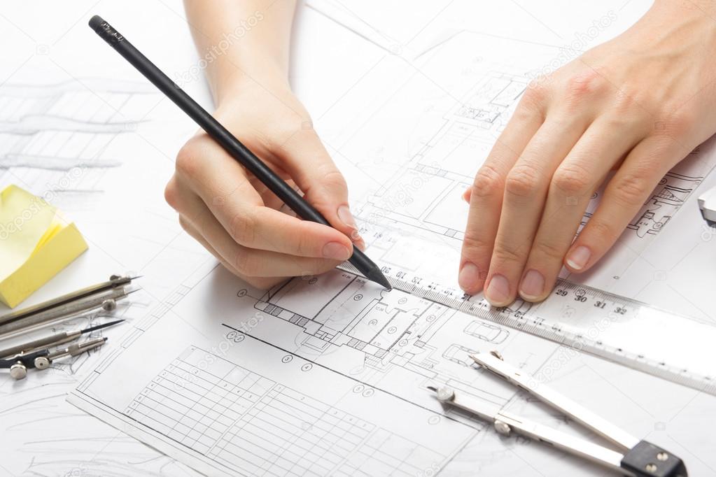 Architect working on blueprint. Architects workplace - architectural project, blueprints, ruler, calculator, laptop and divider compass. Construction concept. Engineering tools