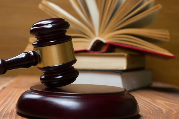 Law book with wooden judges gavel on table in a courtroom or law enforcement office. — Stock Photo, Image