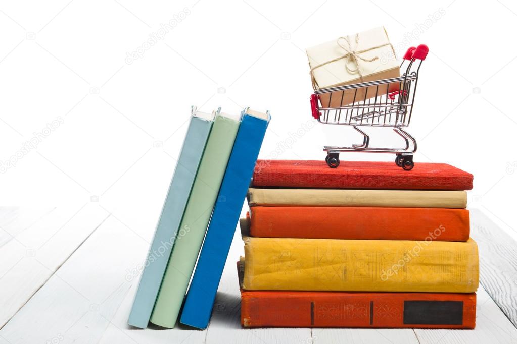 Stack of books at wooden shelf isolated on white background. Back to school. Copy space for text