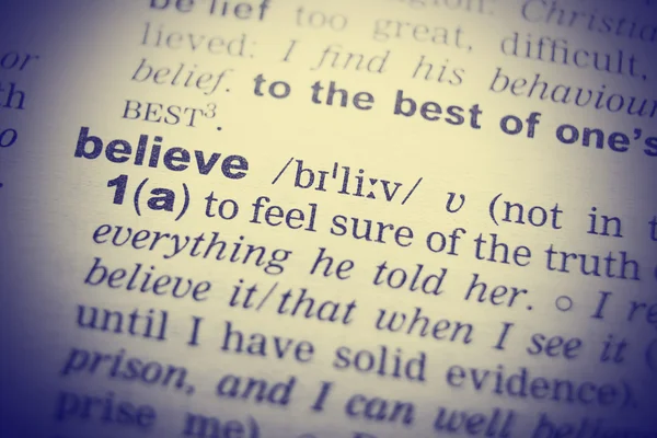 Close-up of word in English dictionary. Belief, definition and transcription — Stock Photo, Image