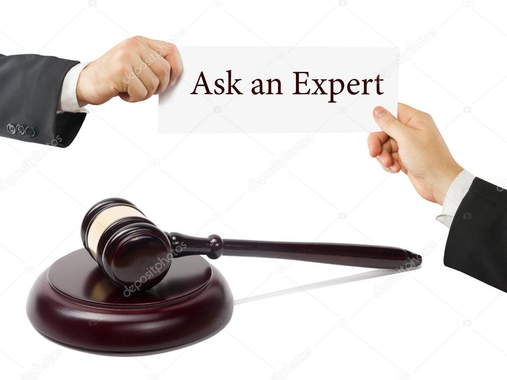 Wooden judges gavel on table in a courtroom or law enforcement office. Lawyer Hands holding business card with text Ask an Expert