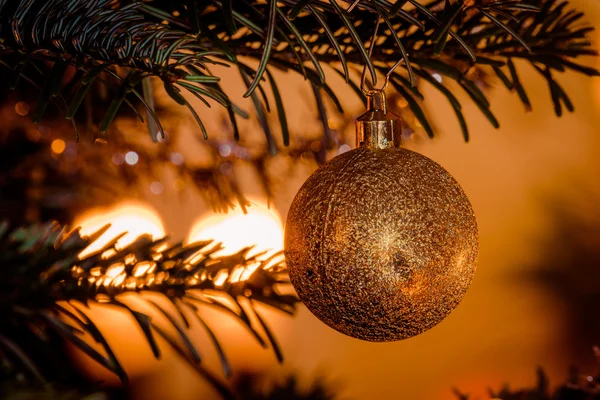 Bola de Natal dourada pendurada na árvore — Fotografia de Stock