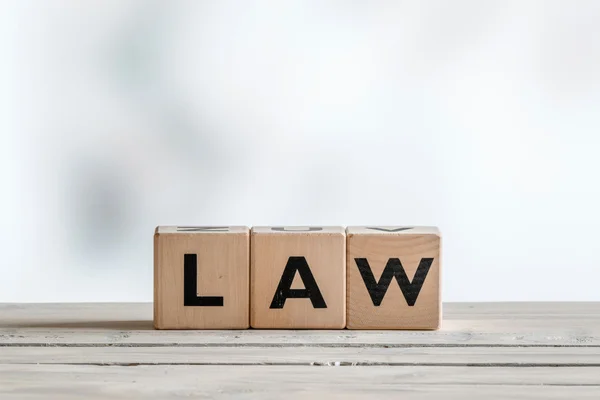 Law sign on a wooden desk — Stock Photo, Image