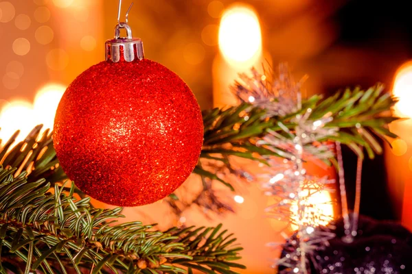 Red Christmas bauble and shiny lights — Stock Photo, Image