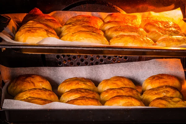 Buns in a hot oven — Stock Photo, Image