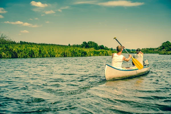 Two caucasian boys in a canoe — Stock Photo, Image