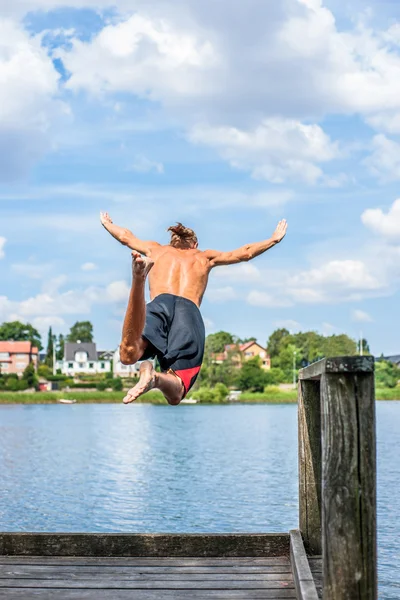 Man jumping into the water — Stock Photo, Image