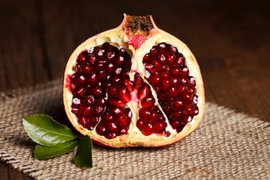 Half-cutted pomegranate on canvas clipart