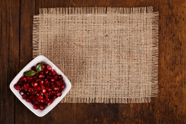 Grenadine seeds in white plate — Stock Photo, Image