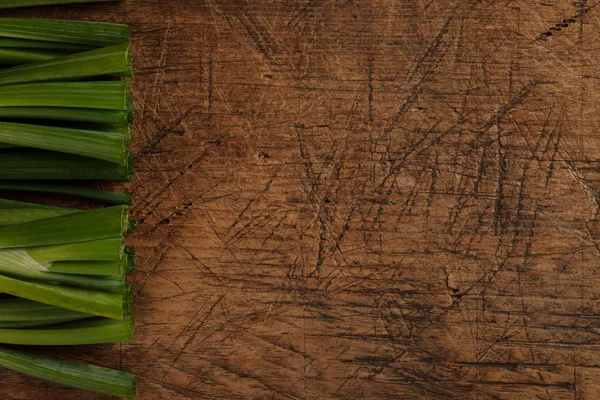 Green onion sticks on wooden table — Stock Photo, Image